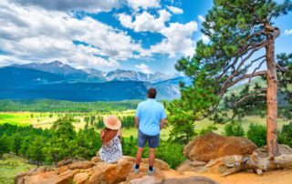 A couple on a wellness retreat in Estes Park, looking at the Rocky Mountains