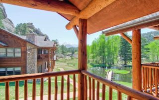 A view of the fall River and trees from the balcony of an Estes Park condo rental