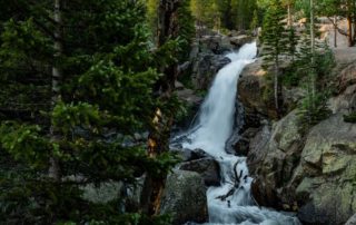 A rushing waterfall in Estes Park during the summer