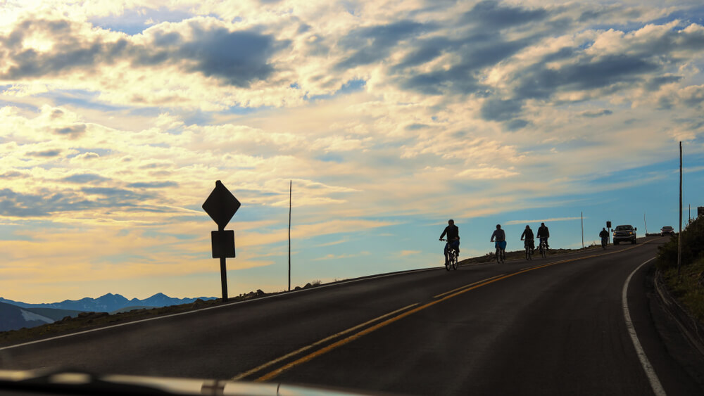 Cyclists biking on Trail Ridge Road in Rocky Mountain National Park during the summer