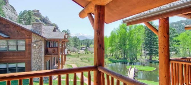 A view of the fall River and trees from the balcony of an Estes Park condo rental