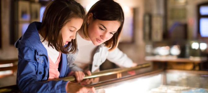 A mother and daughter looking at artifacts at a museum in Estes Park